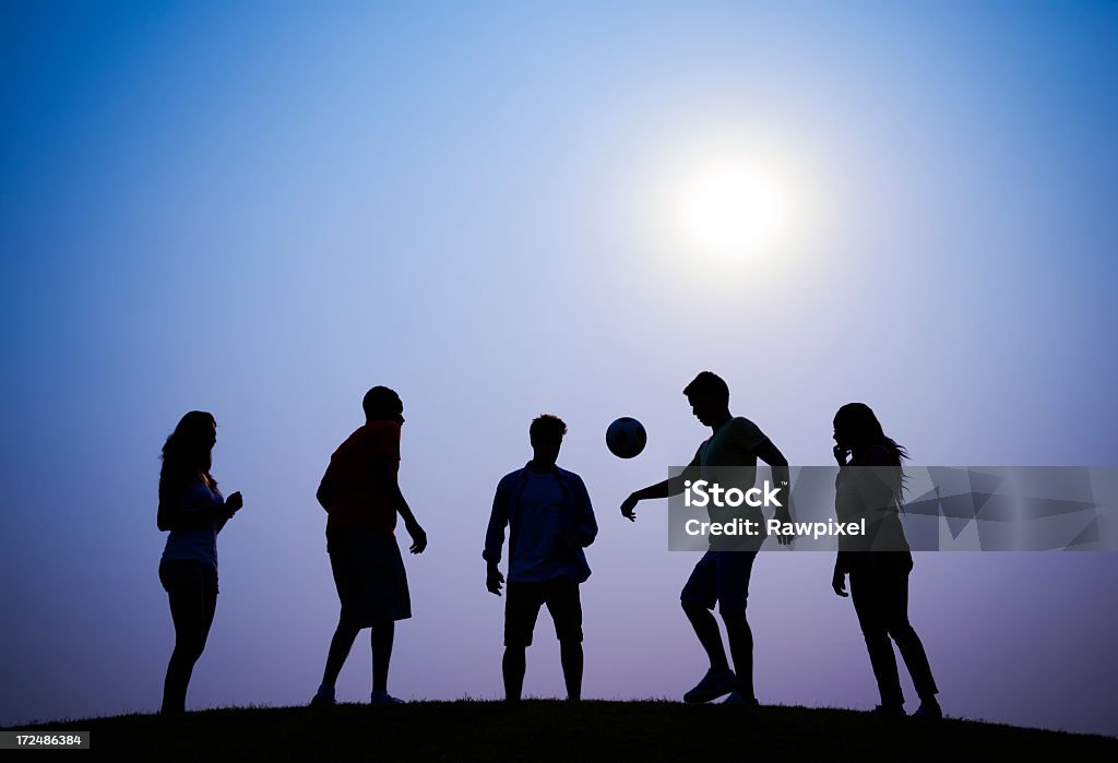 Calcio al tramonto - Foto stock royalty-free di Sagoma - Controluce