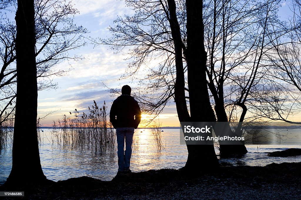 Man standing on lake Adult Stock Photo