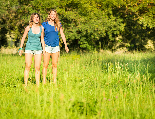 istock two friends standing on the park 172487031