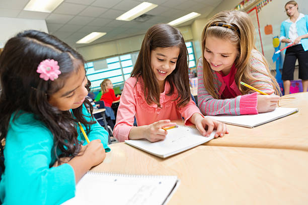 istock Cute elementary age girls studying together in public school classroom 172487227