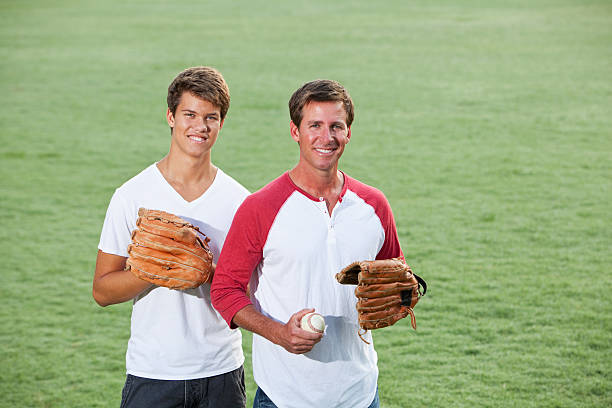 istock Father and teenage son playing baseball 172487362