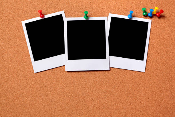 istock Three blank photos pinned to a cork board 172487454