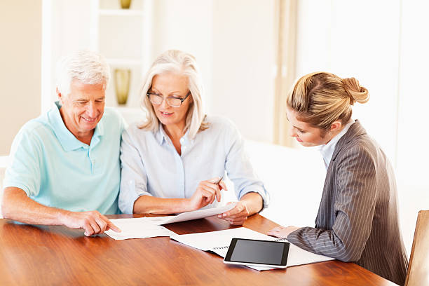 istock Couple Discussing Paperwork With Financial Consultant 172488070