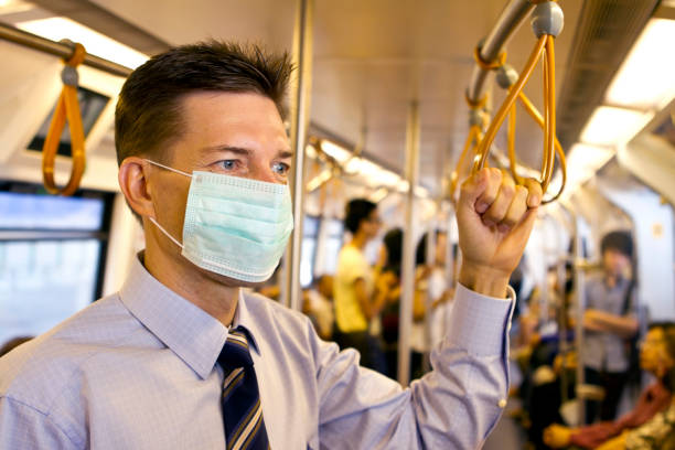 Matured business man wearing a protective mask in subway stock photo