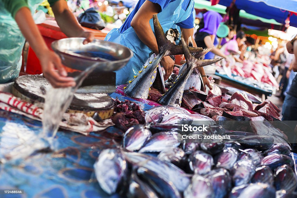Selling Fresh Fish at the Market, Malaysia Fresh fish on the market and people Animal Body Part Stock Photo