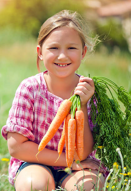 istock Little girl with carrots 172489019