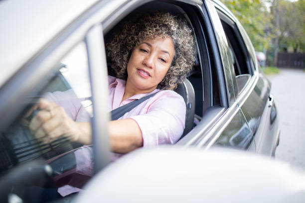 istock Woman is driving a car on her way to work 1724920678