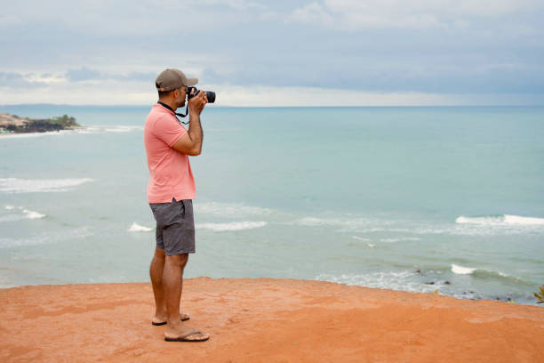 istock Man photographing  on the beach. Tourism concept. 1724973139