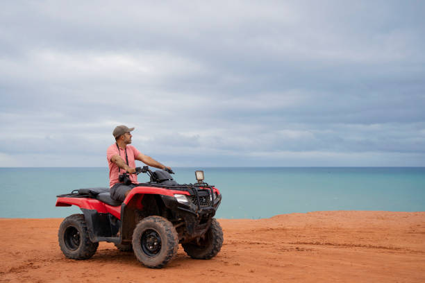 istock Tourist using four wheel motorcycle at the beach 1724973140