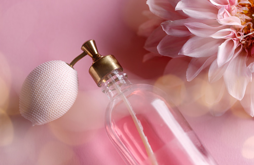 Old perfume bottle with pink flower