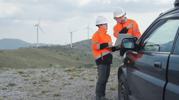 istock Wind energy engineers working in wind turbine farm. 1724982202