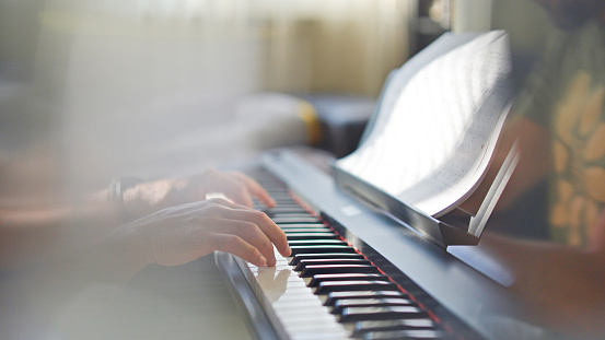 The single lifestyle. Close up of hands playing the piano for relax.