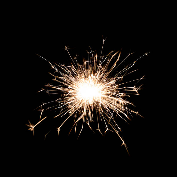 istock Sparkling burning sparkler on a black background. 1724985180