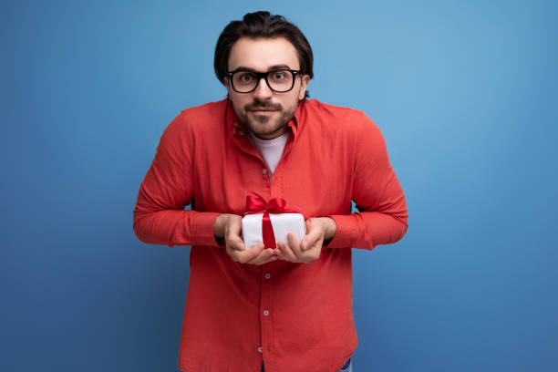 istock joyful cute young guy with chic black hair received a gift 1724995787
