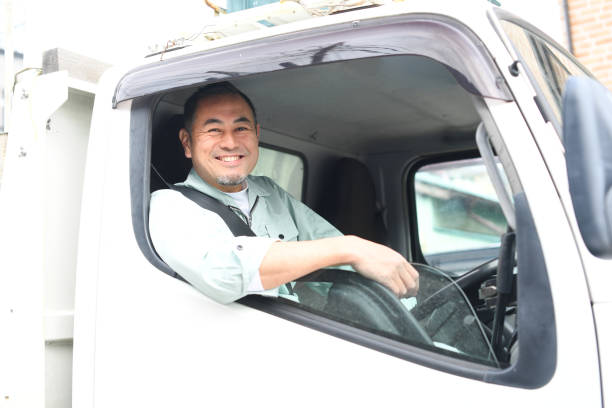 istock Middle-aged Asian worker man looking at camera driving a truck 1724997615