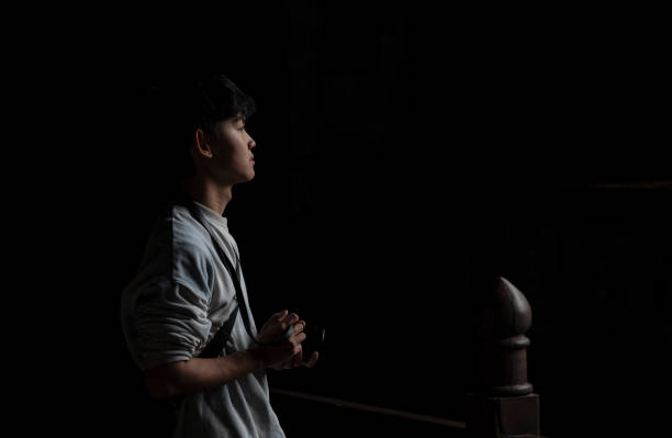 Asian young man with camera in temple. Datong, China