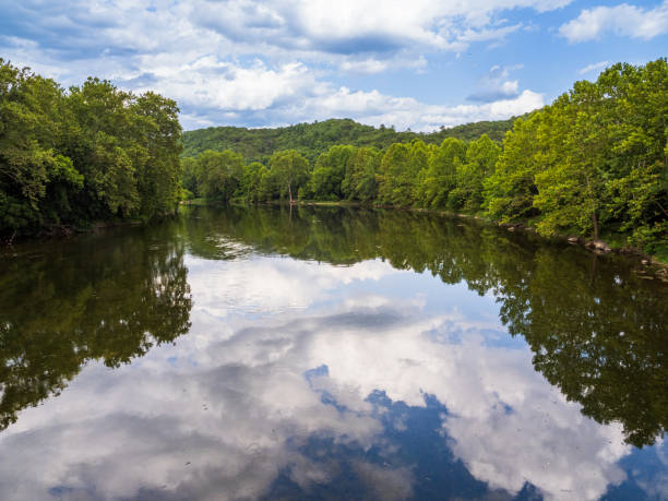 istock Shenandoah River South Fork with trees, sky and clouds reflecting in the still water in Virginia, USA. 1725078684