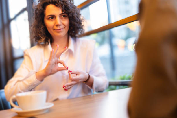istock Two young woman communicate with sign language 1725085100