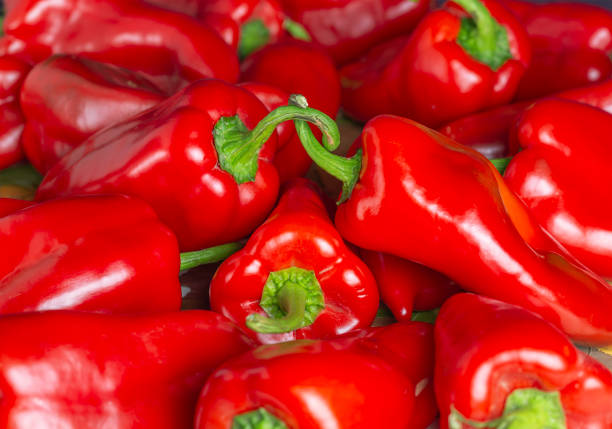 background of red bell pepper with green tail