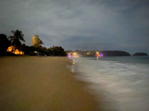 Night beach, sea breeze, can see lights in the distance