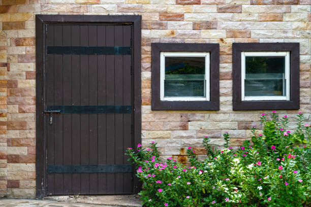 brown wooden door and window with brick wall background