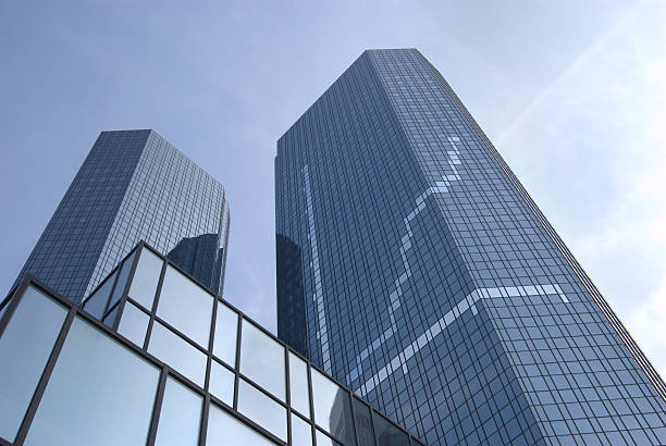 mirrored-glass skyscraper showing chart on the facade.