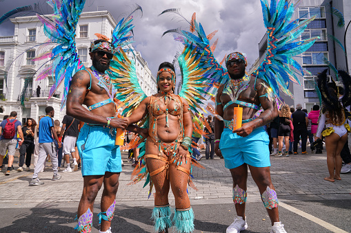 Ladbroke Grove, Notting Hill, West London, England, United Kingdom, Great Britain - 28 August 2023: Black dancers with traditional carnival outfits on the street at the Traditional Parade of the Notting Hill Carnival 2023 festival in London, UK.