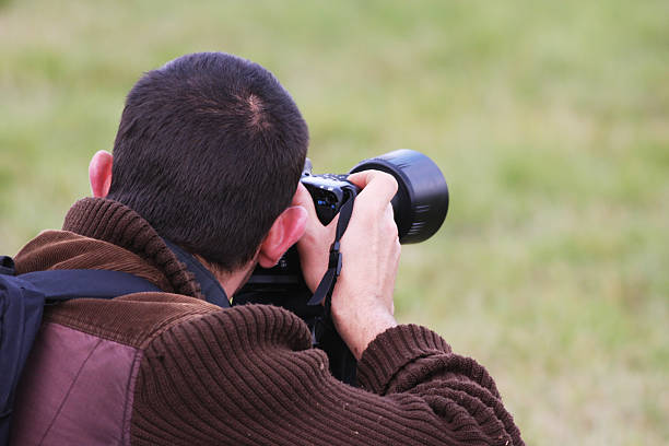 istock Man with camera photographing nature 172513374