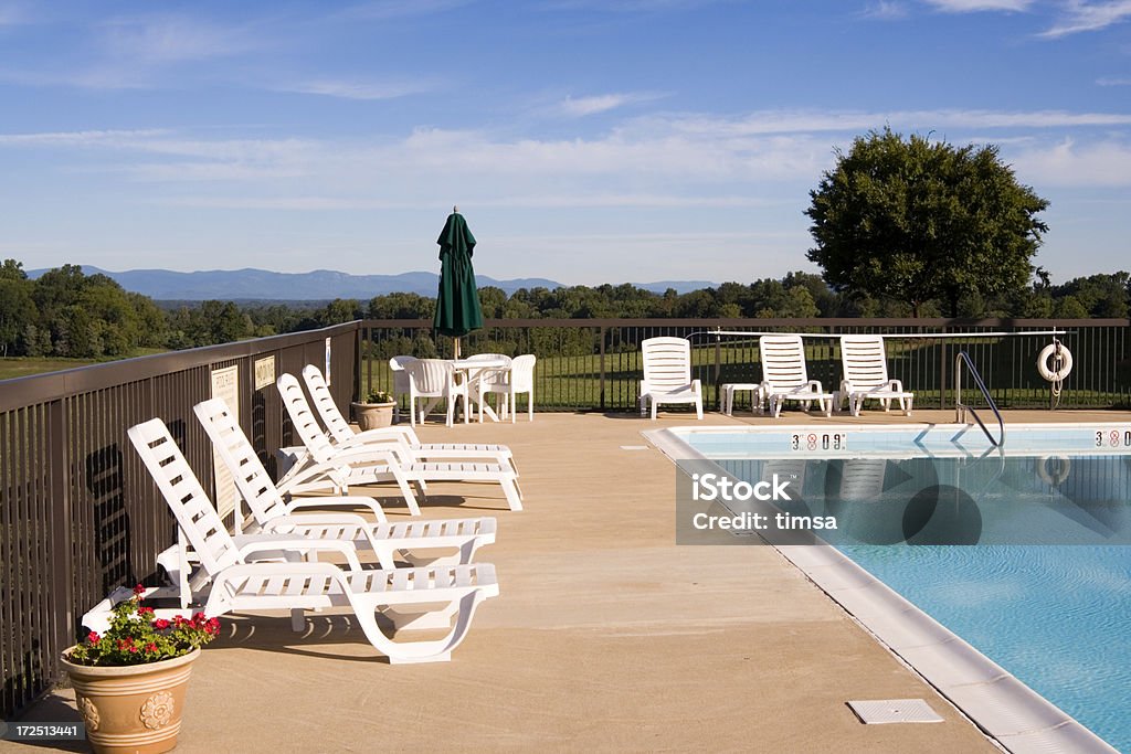 Poolsides "Outdoor pool in bucolic surroundings. Morning sun. Shenandoah valley mountains in the distance, Virginia, United States. Similar:" Deck Chair Stock Photo