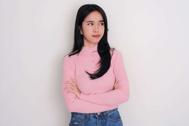 istock Young woman crossed her arms and looking to the left side with skeptical expression 1725139955