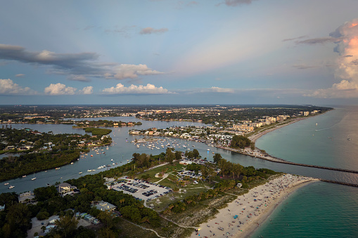 Aerial evening seascape with Nokomis sandy beach in Sarasota County, USA. Many tourists enjoing summer vacation time swimming in warm Mexico gulf water and sunbathing on hot Florida sun.