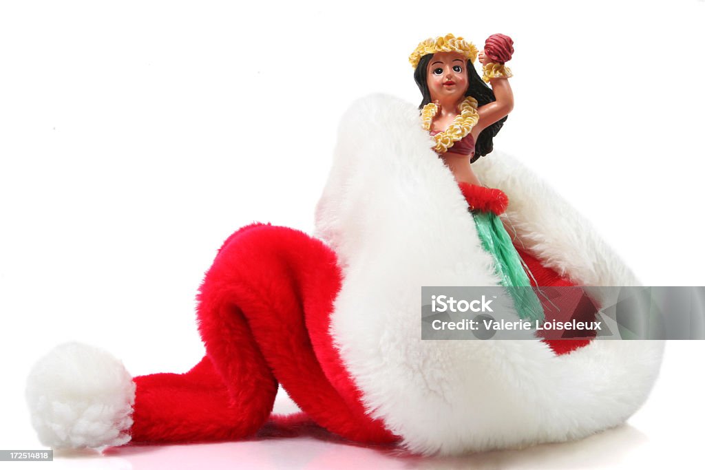 Hawaiian Christmas Santa hat and hula dancer on a white background. Concept Hawaiian Christmas Christmas Stock Photo