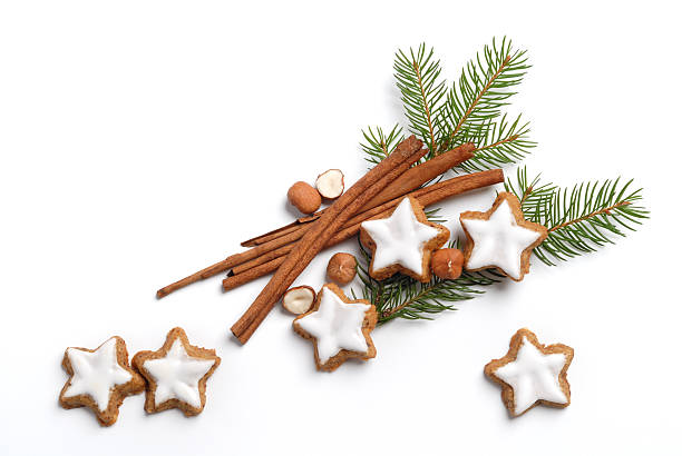 Christmas pine with frosted sugar cookies and cinnamon Christmas arrangement with cinnamon, cookies, nuts and decoration on white. See also the versions: christmas cookies stock pictures, royalty-free photos & images