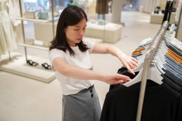 istock Asian woman shopping for clothes 1725152166