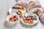Fresh halloween cookies on white wooden table