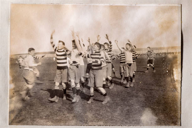 Rugby Vintage photograph from the late Victorian period showing a group of schoolboys playing rugby. rugby team stock pictures, royalty-free photos & images