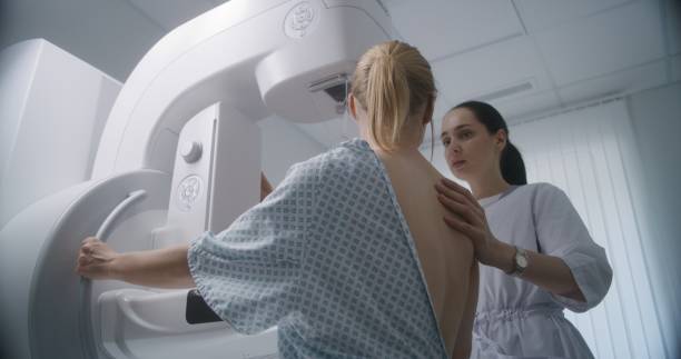 istock Female doctor adjusts modern mammogram machine for patient 1725165021