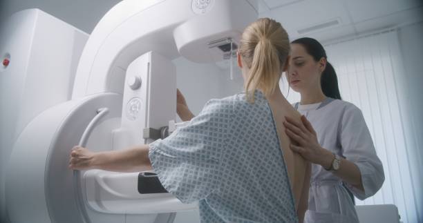 istock Female doctor adjusts modern mammogram machine for patient 1725166618
