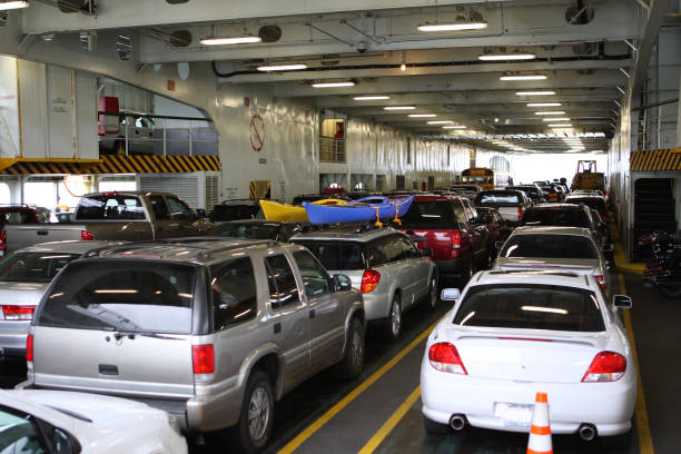 Car Ferry Boat with rows of cars is leaving the port. Car and boat transportation on the sea, river, ocean and water,