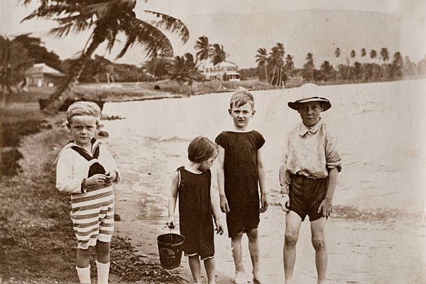 Victorian beach Vintage photograph from the late Victorian early Edwardian period of a group of young children at the seaside. Possibly taken in one of the West Indies colonies. victorian swimwear stock pictures, royalty-free photos & images
