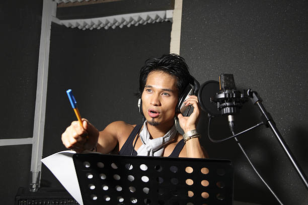 A singer/songwriter in the recording studio. Talking to the producer.