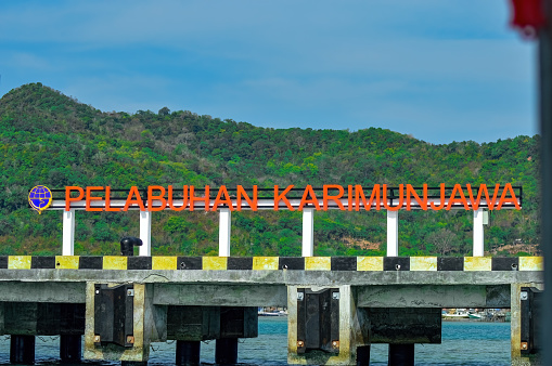 a board writing the name of Karimun Jawa port on the pier, Indonesia, 13 November 2015.