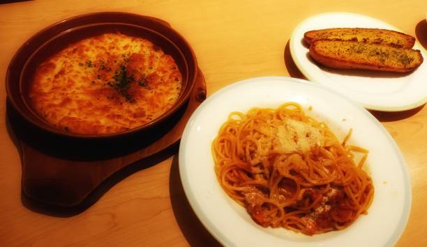 istock Pasta, baked potatoes, and garlic bread 1725181489