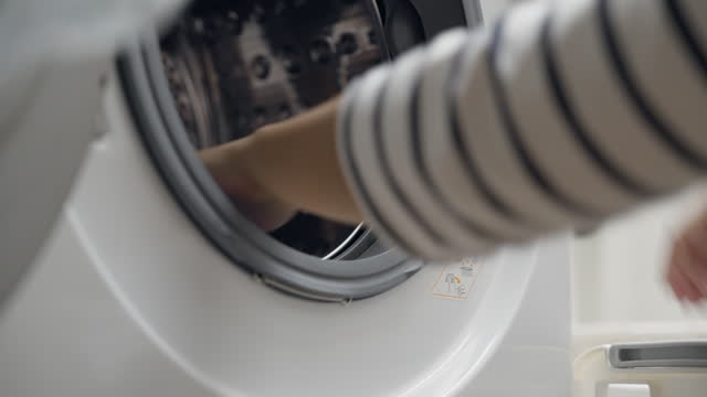 Loading clothes into the automatic washing machine