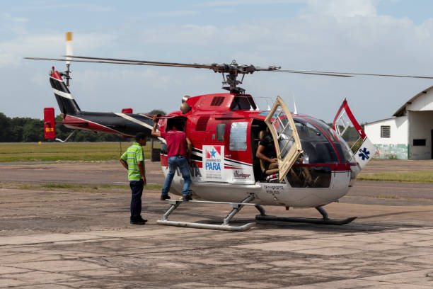Aviation mechanic conducting technical inspection on helicopter Santarem, Para, Brazil - April 06, 2023: Aviation mechanic conducting technical inspection on helicopter before takeoff at Santarem airport para ascending stock pictures, royalty-free photos & images