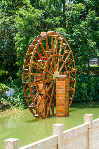 Wooden waterwheel in a pond in rural China