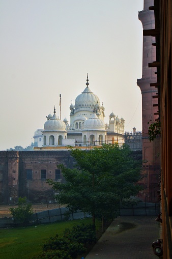 Captured this photograph from Badshahi Mosque the Samadhi of Maharaja Ranjit Singh. The Samadhi of Ranjit Singh (Punjabi: رنجیت سنگھ دی سمادھی (Shahmukhi), ਰਣਜੀਤ ਸਿੰਘ ਦੀ ਸਮਾਧੀ (Gurmukhi); Urdu: رنجیت سنگھ کی سمادھی) is a 19th-century building in Lahore, Pakistan that houses the funerary urns of the Sikh Maharaja Ranjit Singh (1780 – 1839). It is located adjacent the Lahore Fort and Badshahi Mosque, as well as the Gurdwara Dera Sahib, which marks the spot where the fifth guru of Sikhism, Guru Arjan Dev, died. Its construction was started by his son and successor, Maharaja Kharak Singh, after the ruler's death in 1839, and completed nine years later. It overlooks the Hazuri Bagh, built by Ranjit Singh, to its south.