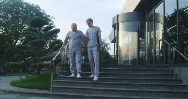 istock Professional doctors in uniform walk near modern clinic 1725263209