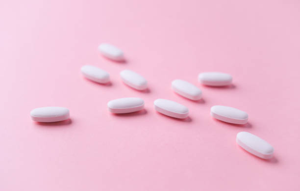 istock White tablets on bright paper background. Soft focus. Close up. Copy space. 1725263399