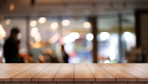 istock Empty wooden table top with lights bokeh on blur restaurant background. 1725287975